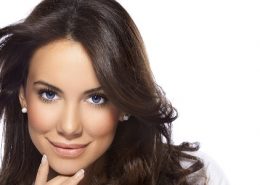 Close-up, beauty shot of a smiling, long haired, young, beautiful, brunette woman isolated over white background. Developed from RAW; retouched with special care and attention; aRGB color profile.
